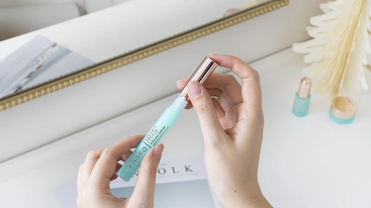 A woman opening IRIS lash serums without prostaglandin